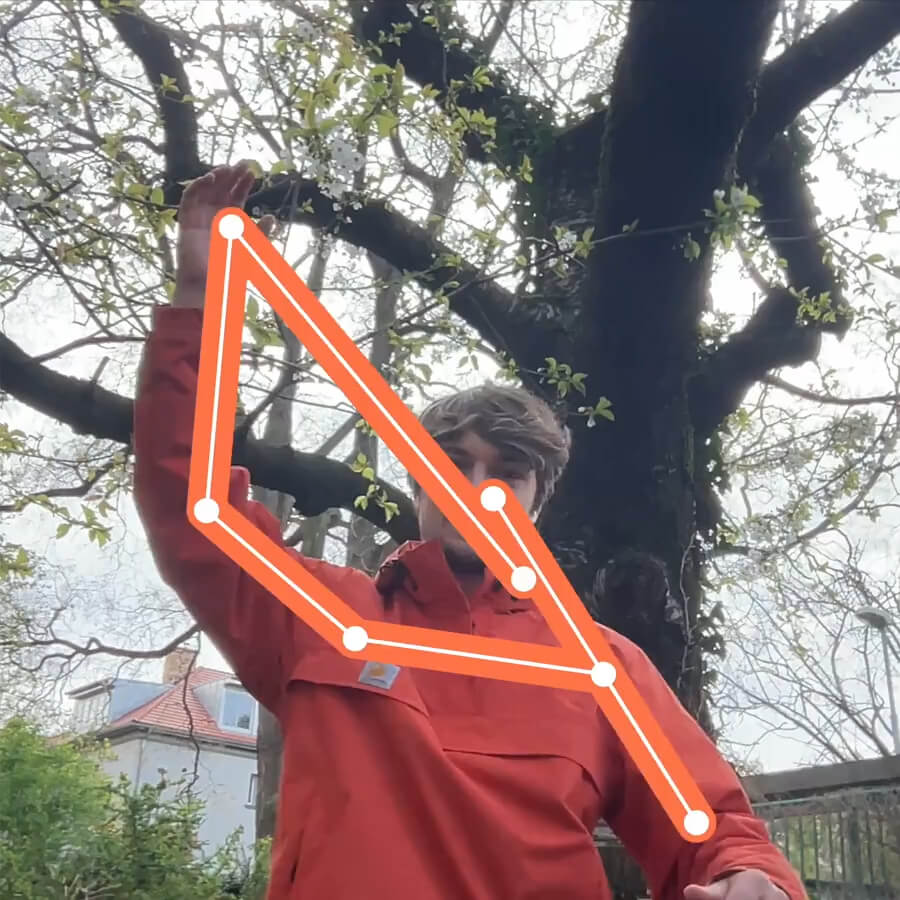 I am waving in front of a tree. My body gets tracked and the tracking points connect to the letter G.